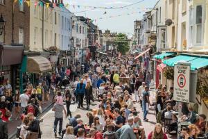 a crowd of people walking down a busy city street at Stylish-1 bedroom flat close to Brighton beach in Brighton & Hove