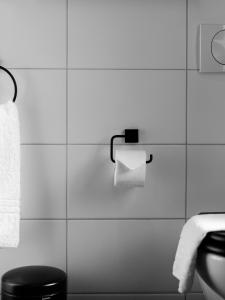 a bathroom with a toilet and a roll of toilet paper at Rey Apartments in Reykjavík