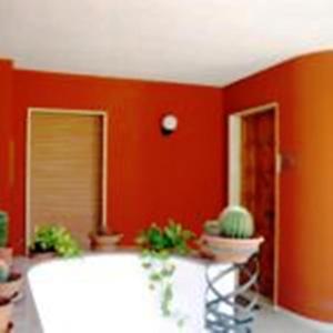 a living room with red walls and a white tub at B&B Santa Lucia in Sogliano Cavour