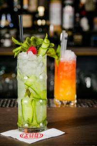 a drink sitting on a table with two drinks at Casati Hotel - Adults Only in Budapest
