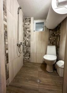 a bathroom with a toilet and a shower at “River Romance” Villa in Kamchia