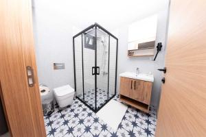 a bathroom with a shower with a toilet and a sink at Foça Kybele in Izmir +32 photos