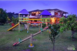 a playground in front of a house with a slide at Hotel Estorake San Agustin Huila in San Agustín