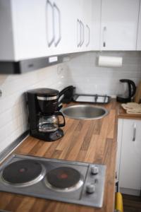 a kitchen counter with a coffee maker on a counter top at Old Town Patio House in Ohrid