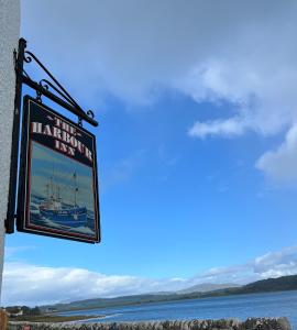 a sign for a marina on the side of a building at The Harbour Inn in Garlieston