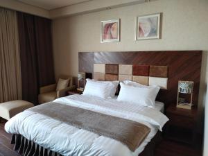 a hotel room with a large bed and a chair at Dreamland Oasis in Chakvi