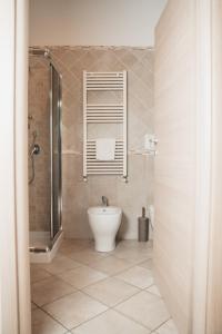 a bathroom with a toilet and a glass shower at B&B Dimora Mariù in Taranto
