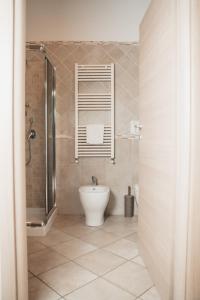 a bathroom with a toilet and a glass shower at Dimora Mariù in Taranto +54 photos
