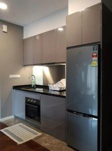 a kitchen with a stainless steel refrigerator and a sink at Vista Residence Genting Highland in Genting Highlands