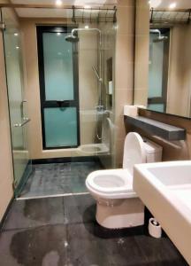 a bathroom with a toilet and a shower and a sink at Vista Residence Genting Highland in Genting Highlands