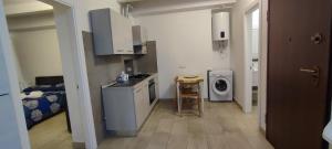 a kitchen with a sink and a washing machine at Archubintu B&B your friendly place in Sassari