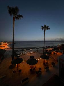 a view of a patio with umbrellas and palm trees at Hotel La Potiniere in Hyères +93 photos