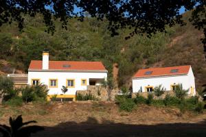 a white house with a red roof on a hill at Casa Alva in Aljezur