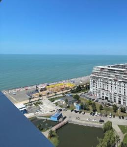 an aerial view of a building next to the ocean at Batumi Continental apartments in Batumi
