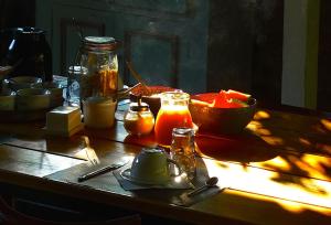 a wooden table with food and a bowl of sauce at A ChiOsella in Corbara