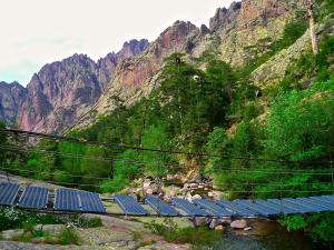 a group of solar panels in front of a mountain at A ChiOsella in Corbara