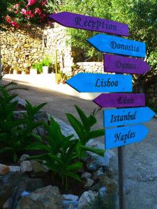 a street sign with arrows pointing in different directions at A ChiOsella in Corbara