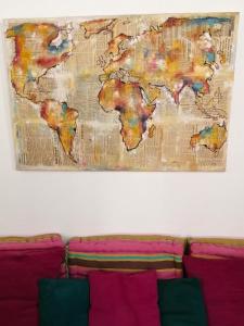 a map of the world hanging above a couch at A ChiOsella in Corbara