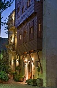 a building with a tree house on the side of it at Ionas Boutique Hotel in Chania