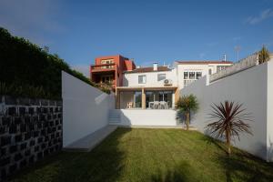 vistas al patio trasero de una casa en Figueiras House Pópulo Beach en Ponta Delgada