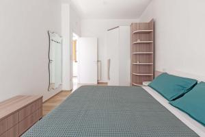 a bedroom with a bed and a book shelf at Appartamento Vitalba by BarbarHouse in Ginosa Marina