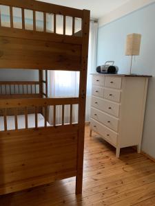 a bedroom with a bunk bed and a dresser at Spreewaldhaus Melcher in Leipe
