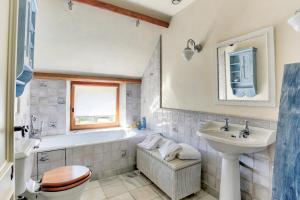 a bathroom with a tub and a sink at Demeure des Hauts Champs - à 800m de la plage de Pen Guen in Saint-Cast-le-Guildo +24 photos