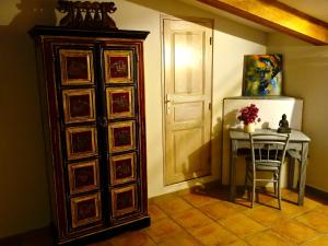 a room with a table and a refrigerator and a door at A ChiOsella in Corbara