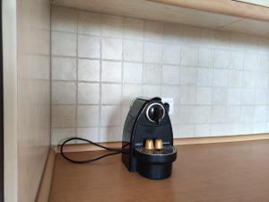 a black iron with candles in the corner of a room at Balcony House in Leptokarya