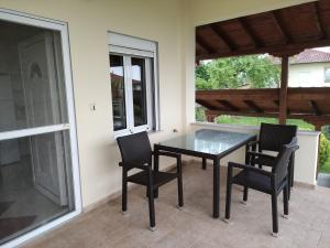 a black table and chairs on a patio at Balcony House in Leptokarya