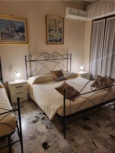 1 Schlafzimmer mit 2 Betten, 2 Tischen und 2 Lampen in der Unterkunft Maison Manni' B&B in Soverato Marina