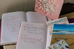 a stack of books with handwriting and papers on a table at B&B Molenaar in Buren