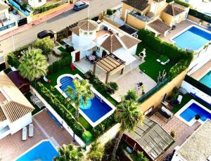 an aerial view of a house with two swimming pools at Casa Buena Vista with private pool in Mazarrón