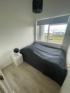 Postel nebo postele na pokoji v ubytování Heiðarbrún