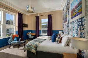 a bedroom with a large bed and a window at Plockton Inn in Plockton