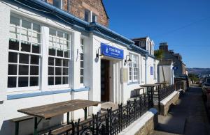 a couple of tables on the side of a building at Plockton Inn, by Highland Coast Hotels in Plockton