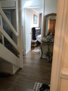 a hallway with a staircase and a mirror at Stoddart House in Newcastle upon Tyne