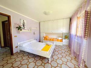 a small bedroom with two beds in it at Villa Eden in Domusnovas