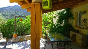 a table and chairs on a patio with a view at A ChiOsella in Corbara