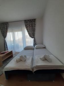a bedroom with a large bed with two pillows at Apartmani Pantovic - Apartman 1 in Trebinje