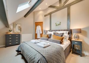 a bedroom with a large bed and a mirror at Church Beck Retreat in Scalby