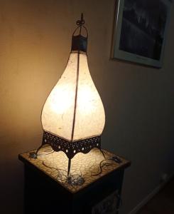 a lamp on top of a table in a room at Studio a Clermont Ferrand in Clermont-Ferrand