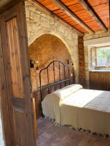 a bedroom with two beds in a stone wall at Romanos Villa in Paphos