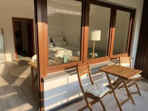 a room with a table and a chair and a mirror at FeWo in ruhiger Aussichtslage in Bad Liebenzell +9 photos