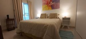 a bedroom with a white bed with a window at La Casa de Mirna in Formosa