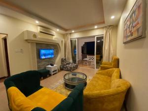 sala de estar con 2 sofás y TV en Lux Suites Shanzu Beachfront Apartments, en Shanzu