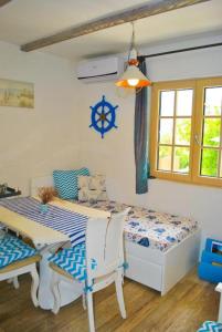 a bedroom with a bed and a table and a window at Casa Mediterraneo Perast in Perast
