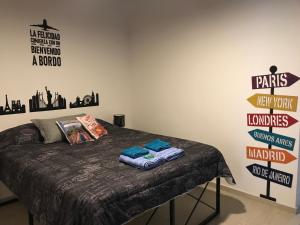 1 cama en una habitación con carteles en la pared en Departamento Ameghino 2do piso en San Juan