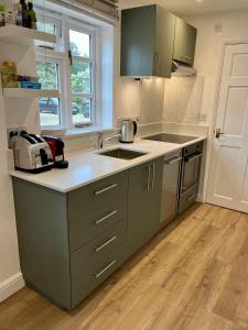 a kitchen with a sink and a counter top at Studio at The Old Vicarage in Abingdon