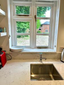 a kitchen with a sink and a window at Studio at The Old Vicarage in Abingdon